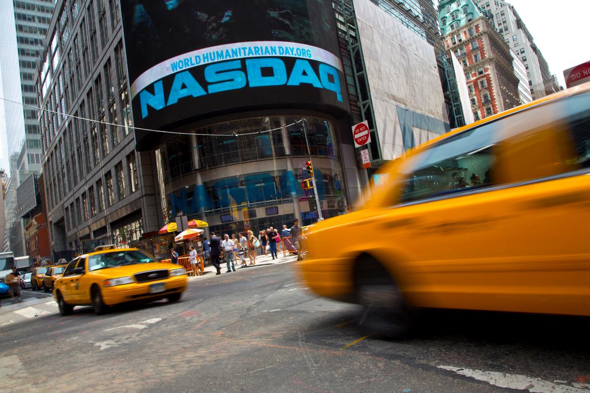 Taxi cabs drive past the Nasdaq MarketSite in New York's Times Square, U.S. on Aug. 23, 2013. (Andrew Kelly/Reuters)