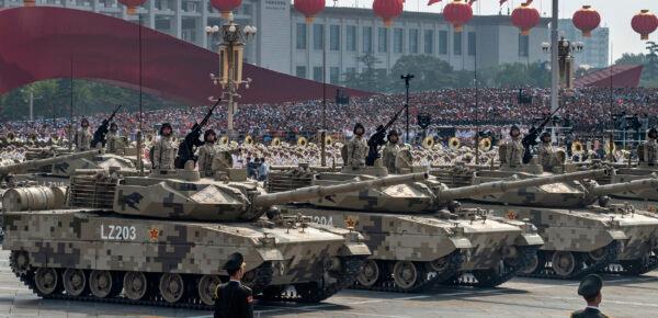 Chinese soldiers sit atop tanks as they drive in a parade to celebrate the 70th anniversary of the Communist Party’s takeover of China, at Tiananmen Square in Beijing on Oct. 1, 2019. (Kevin Frayer/Getty Images)