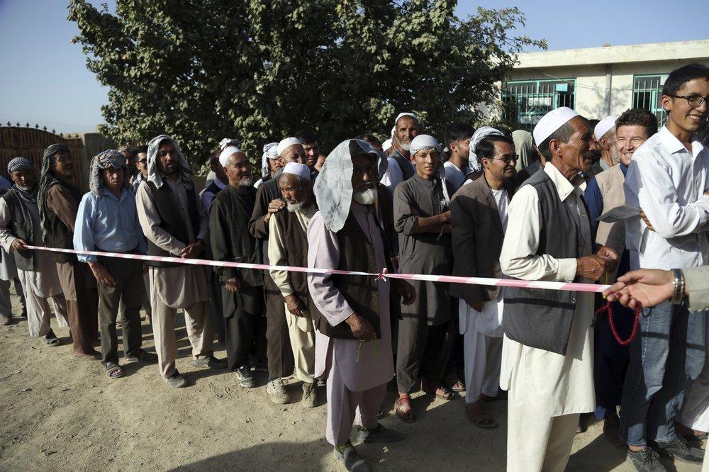 Men line up outside a polling station in the western neighborhood of Kabul, Afghanistan, on Saturday, Sept. 28, 2019. (Rahmat Gul/AP Photo)