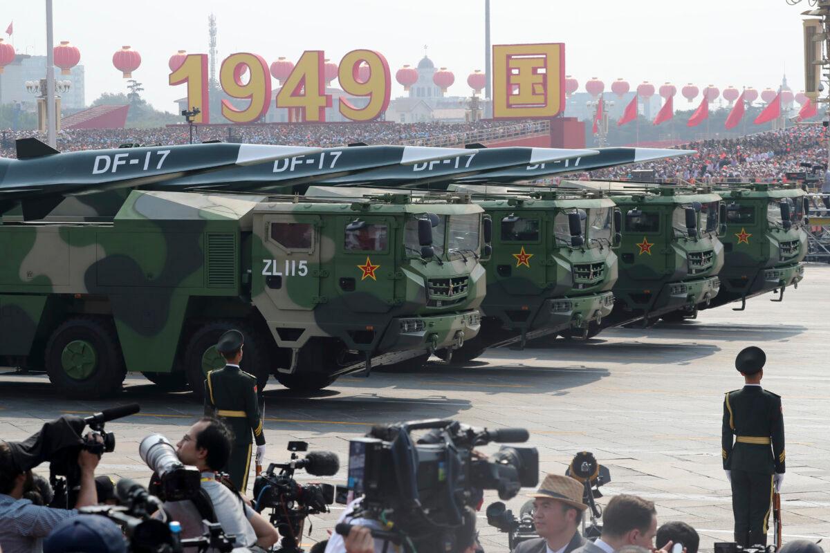 Military vehicles, carrying DF-17, roll down as members of a Chinese military honor guard march during the parade to commemorate the 70th anniversary of the Chinese Communist Party's takeover of China, in Beijing on Oct. 1, 2019. China's military has shown off a new hypersonic ballistic nuclear missile believed capable of breaching all existing anti-missile shields deployed by the United States and its allies. (Ng Han Guan/AP Photo)