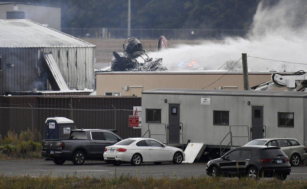 A fire-and-rescue operation is underway where World War II-era bomber plane crashed at Bradley International Airport in Windsor Locks, Conn., on Oct. 2, 2019. (AP Photo/Jessica Hill)