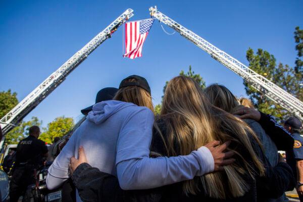 Friends hug outside the Los Robles Medical Center as they pay tribute to Ventura County Sgt. Ron Helus in Thousands Oaks, California, on Nov. 8, 2018. (Apu Gomes/AFP/Getty Images)