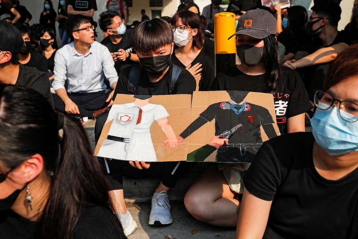 Alumnus of Tsuen Wan Public Ho Chuen Yiu Memorial College participate in a student gathering in the school in solidarity with the student protester, Tony Tsang, who was shot by a policeman on Oct. 1 in Tsuen Wan, Hong Kong, China, on Oct. 2, 2019. (Susana Vera/Reuters)