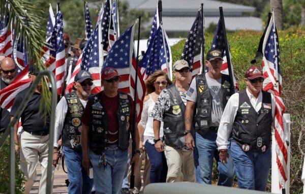 A motorcycle group carries American flags during an open funeral service for U.S. Army veteran Edward K. Pearson, at the Sarasota National Cemetary in Sarasota, Fla. on Oct. 1, 2019. (Chris O'Meara/AP Photo)