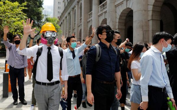 Office workers wearing masks attend a lunch time anti-government protest after local media reported on an expected ban on face masks under emergency law, at Central in Hong Kong on Oct. 4, 2019. (Tyrone Siu/Reuters)