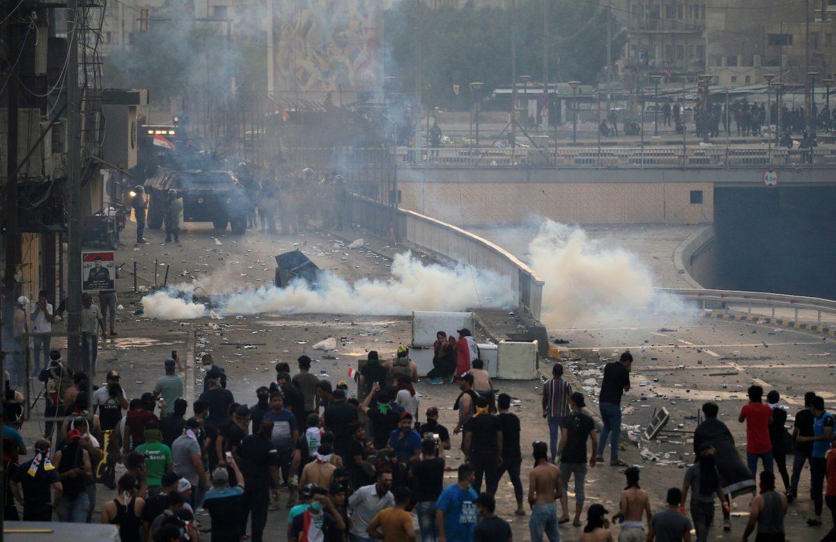 Demonstrators disperse as Iraqi security forces use tear gas during a protest over unemployment, corruption and poor public services, in Baghdad, Iraq on Oct. 2, 2019. (Thaier al-Sudani/Reuters)