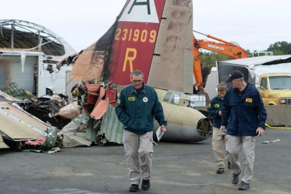 NTSB investigator-in-charge Bob Gretz (L) with NTSB colleagues at the scene of a World War II-era bomber plane that crashed Wednesday at Bradley International Airport in Windsor Locks, Conn. (National Transportation Safety Board via AP)