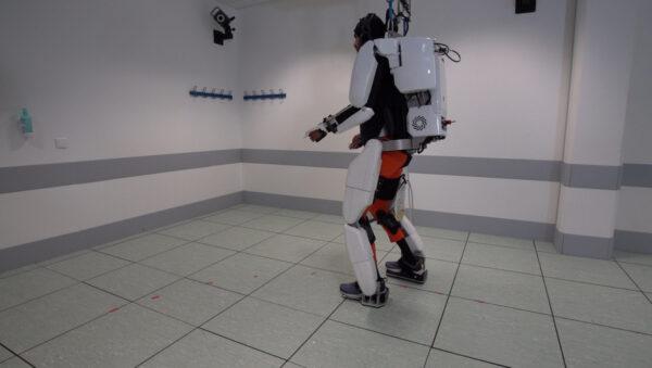 A patient with tetraplegia walks using an exoskeleton in Grenoble, France, in Feb. 2019, in this still image taken from a video handout. (Fonds De Dotation Clinatec/La Breche/Reuters)