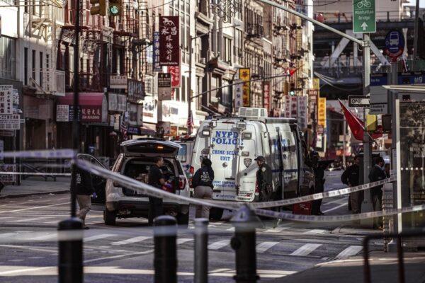 New York Police Department officers investigate the scene of an attack in Manhattan's Chinatown neighborhood, Saturday, Oct. 5, 2019 in New York.  (AP Photo/Jeenah Moon)