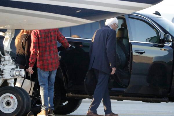 Democratic presidential candidate Sen. Bernie Sanders (I-Vt.), right, enters a vehicle after disembarking from a plane at Burlington International Airport in South Burlington, Vt., on Oct. 5, 2019. (Steven Senne/AP Photo)