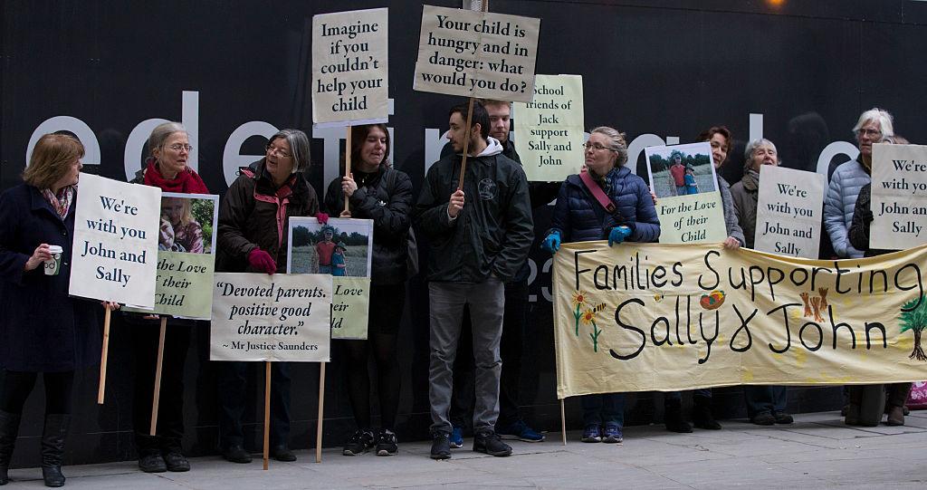 Supporters of John Letts and Sally Lane, parents of Jack Letts who joined ISIS and has been in a Kurdish prison since 2017, hold banners outside the Old Bailey in central London on Jan. 12, 2017. (DANIEL LEAL-OLIVAS/AFP/Getty Images)