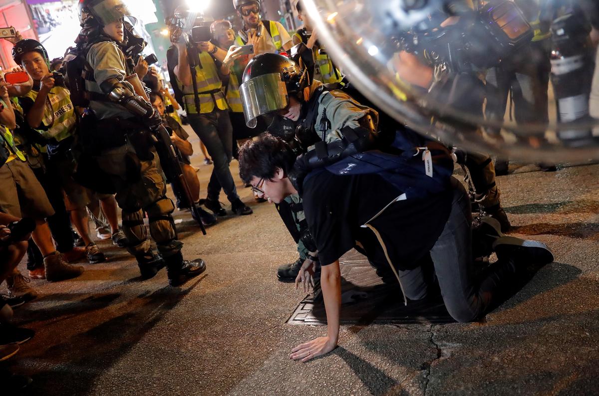 Riot police detain a person during a pro-democracy rally in Hong Kong on Oct.7, 2019. (Susana Vera/Reuters)