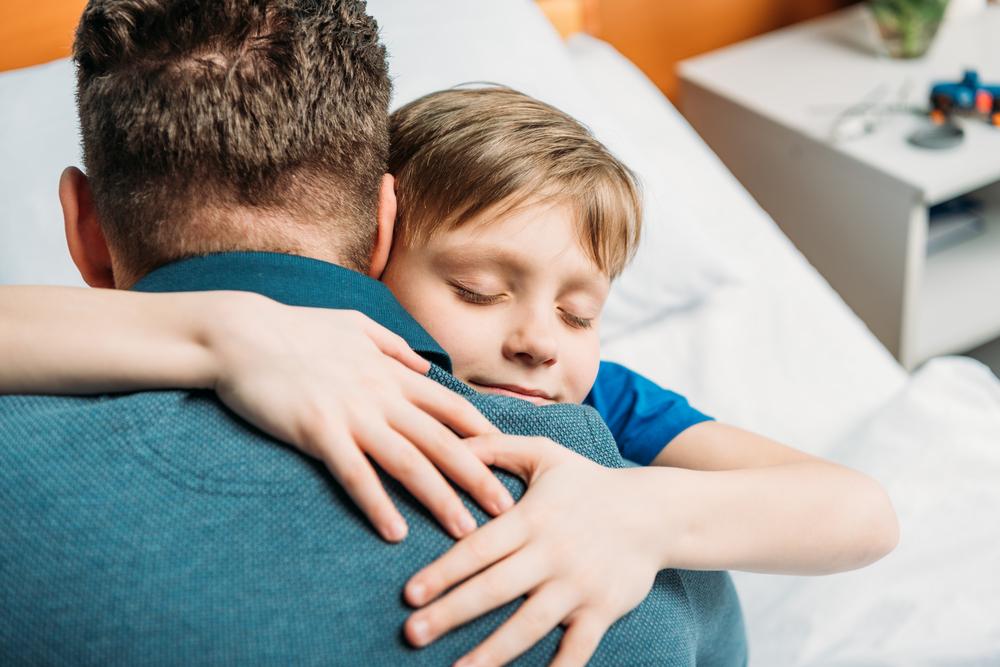Illustration - Shutterstock | <a href="https://www.shutterstock.com/image-photo/portrait-little-son-hugging-father-hospital-641812057?src=1a-Drns6d1r-vJduTwP49A-1-0">LightField Studios</a>