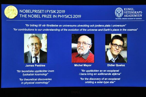 A screen displays the portraits of the laureates of the 2019 Nobel Prize in Physics, with left to right, James Peebles, Michel Mayor and Didier Queloz, during a news conference at the Royal Swedish Academy of Sciences in Stockholm, Sweden, on Oct. 8, 2019. (Claudio Bresciani / TT via AP)