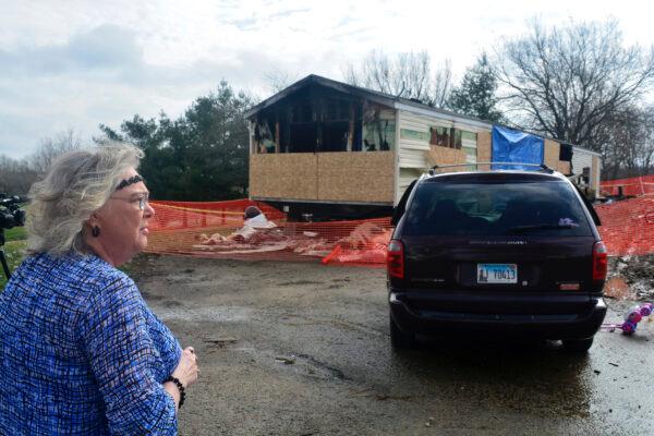 Marie Chockley, a resident of the Timberline Trailer Court, north of Goodfield, Ill., surveys the damage that was caused by a Saturday night fire that killed five residents in a mobile home on April 7, 2019. (Kevin Barlow/The Pantagraph via AP)