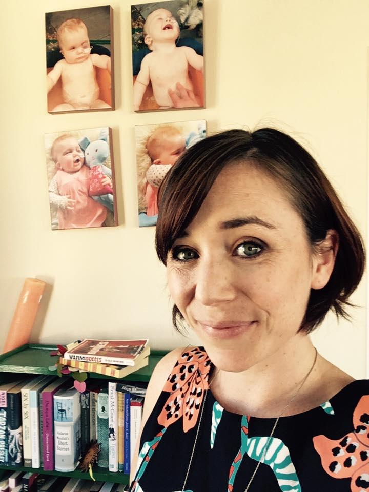 Tessa at her apartment in Wellington City in front of photos of Eva before giving a speech at a Rare Disease Day event in 2016. (Photo courtesy of <a href="http://theoneinamillionbaby.com/">Tessa Prebble</a>)