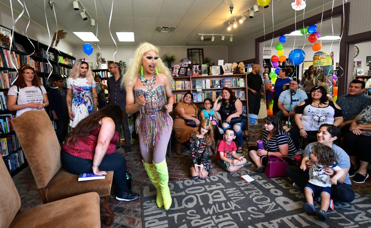 Drag queens Athena Kills (C) and Scalene Onixxx arrive to awaiting adults and children for Drag Queen Story Hour at Cellar Door Books in Riverside, Calif., on June 22, 2019. (Photo by Frederic J. Brown/AFP/Getty Images)