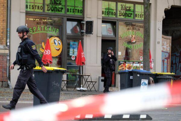 A police officer walks in front of a kebab grill in Halle, Germany on Oct. 9, 2019. (Sebastian Willnow/dpa via AP)