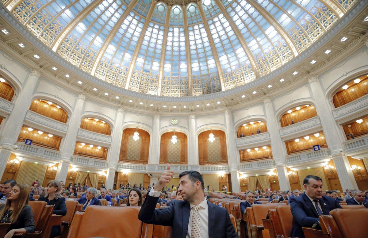 A Romanian member of parliament gives a thumbs up during procedures ahead of a no confidence vote in Bucharest, Romania on Oct. 10, 2019. (Vadim Ghirda/AP Photo)