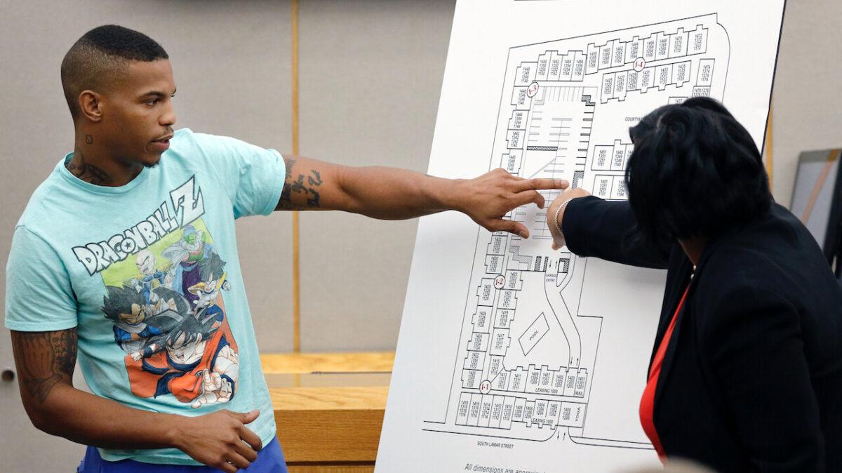 Botham Jean's neighbor Joshua Brown, left, answers questions from Assistant District Attorney LaQuita Long, right, while pointing to a map of the South Side Flats where he and Jean lived on Tuesday, Sept. 24, 2019. (Tom Fox/The Dallas Morning News/AP)