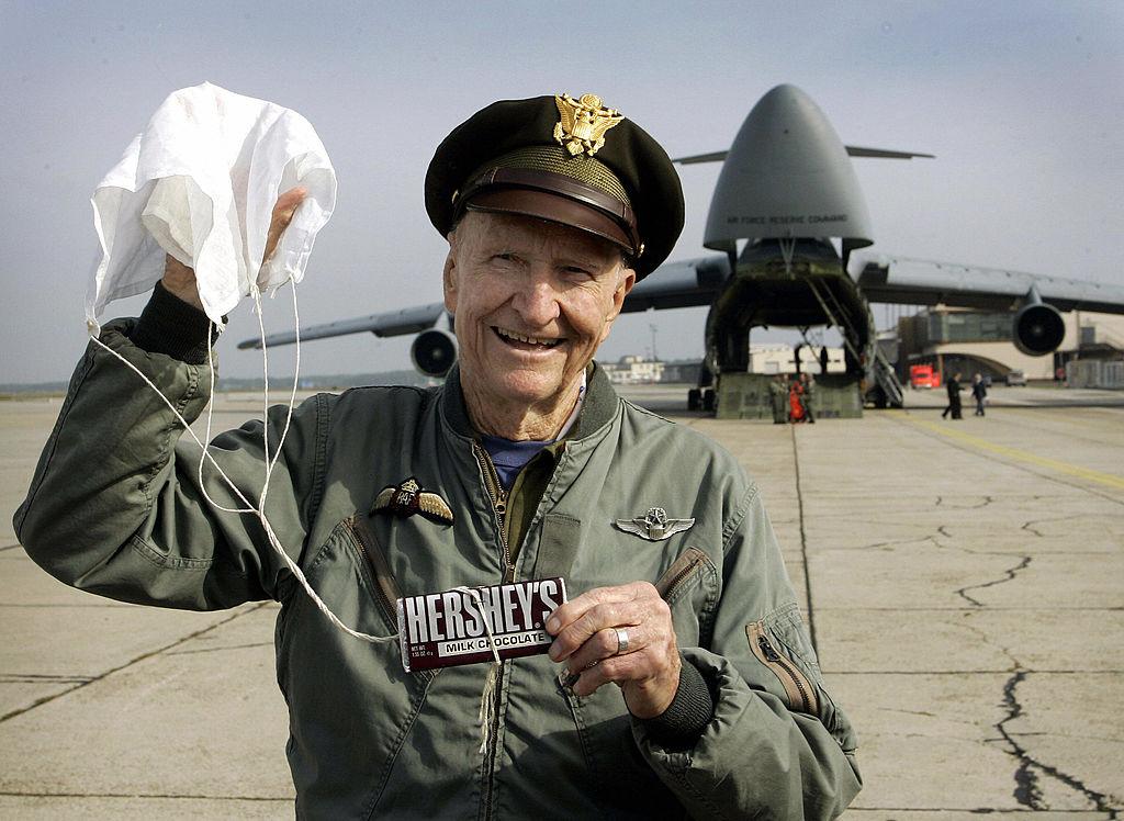Gail S. Halvorsen holds a bar of chocolate attached to a little parachute on Oct. 10,  2005, at the military airbase in Frankfurt/Main Germany. (TORSTEN SILZ/DDP/AFP via Getty Images)