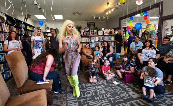 Athena Kills (C) and Scalene Onixxx arrive for Drag Queen Story Hour to an audience of adults and children at Cellar Door Books in Riverside, Calif. on June 22, 2019. (Frederic J. Brown/AFP/Getty Images)