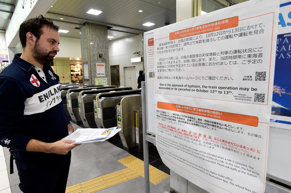An England rugby supporter reads a travel warning sign at Hamamatsu railway station, regarding Typhoon Hagibis and possible train suspensions and cancellations in Hamamatsu, Japan, on Oct. 10, 2019. (Reuters/ Rebecca Naden)