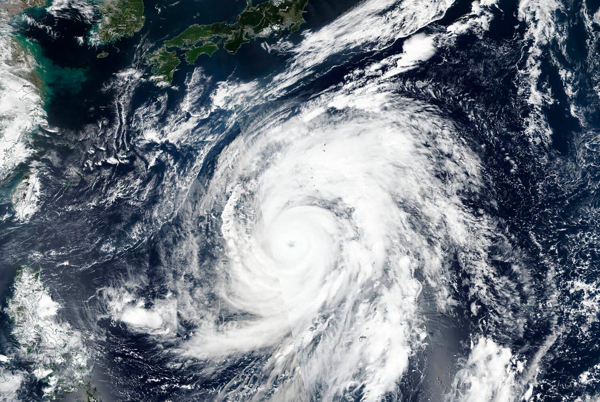 This satellite image provided by the U.S. Navy's Joint Typhoon Warning Center shows typhoon Hagibis approaching Japan, top, on Oct. 10, 2019. (NASA Worldview, Earth Observing System Data and Information System (EOSDIS) via AP)