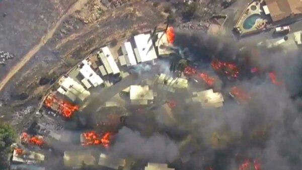 This photo from video provided by KABC-TV shows Strong, gusting winds push flames through the Villa Calimesa mobile home park in Calimesa, Calif., southeast of San Bernardino on Oct. 10, 2019. (KABC-TV via AP)