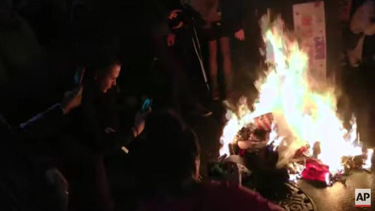 Protesters burn items outside Target Center in Minneapolis, the venue for a Trump rally, on Oct. 10, 2019. (AP)