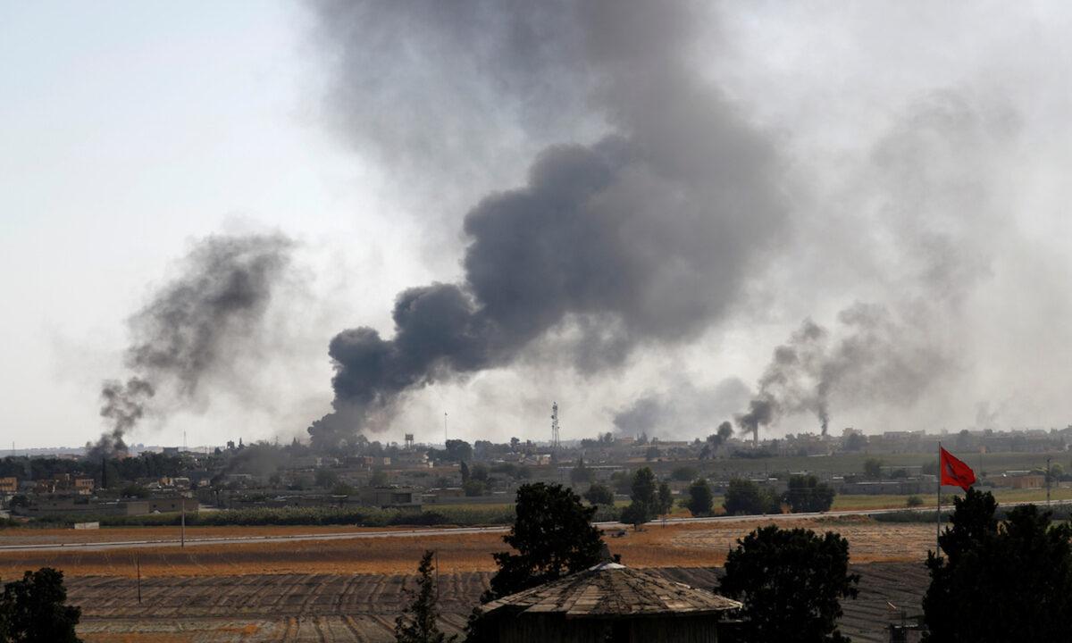 Smoke rises over the Syrian town of Tel Abyad, as seen from the Turkish border town of Akcakale in Sanliurfa province, Turkey, on Oct. 10, 2019. (Murad Sezer/Reuters)