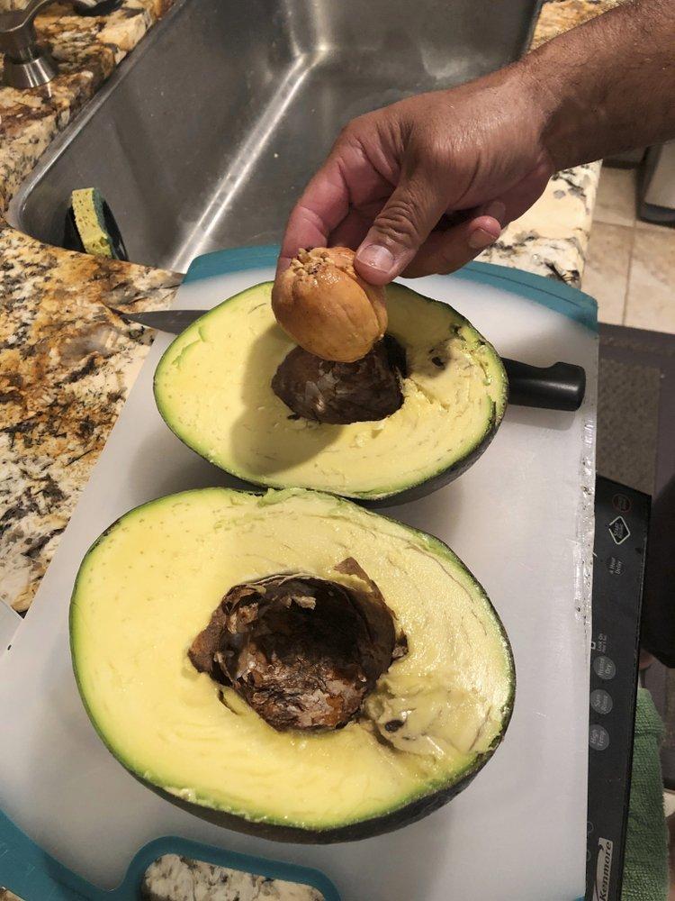 A giant avocado being cut to make into guacamole at Kula Country Farms in Kula,Hawaii on Oct. 11, 2019. (Juliane Pokini via AP)