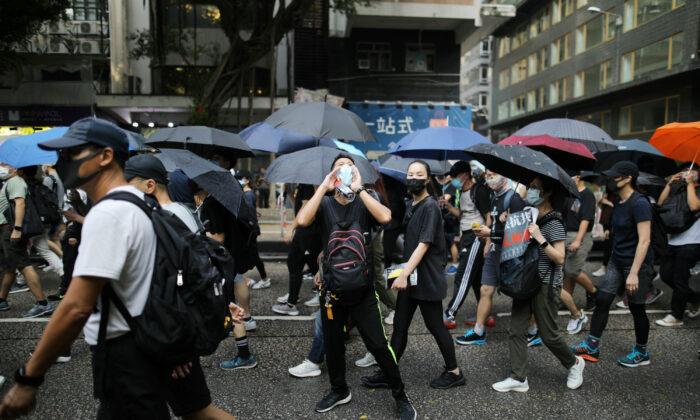Protesters Defy Face Mask Ban; Petrol Bombs Thrown in Hong Kong Metro