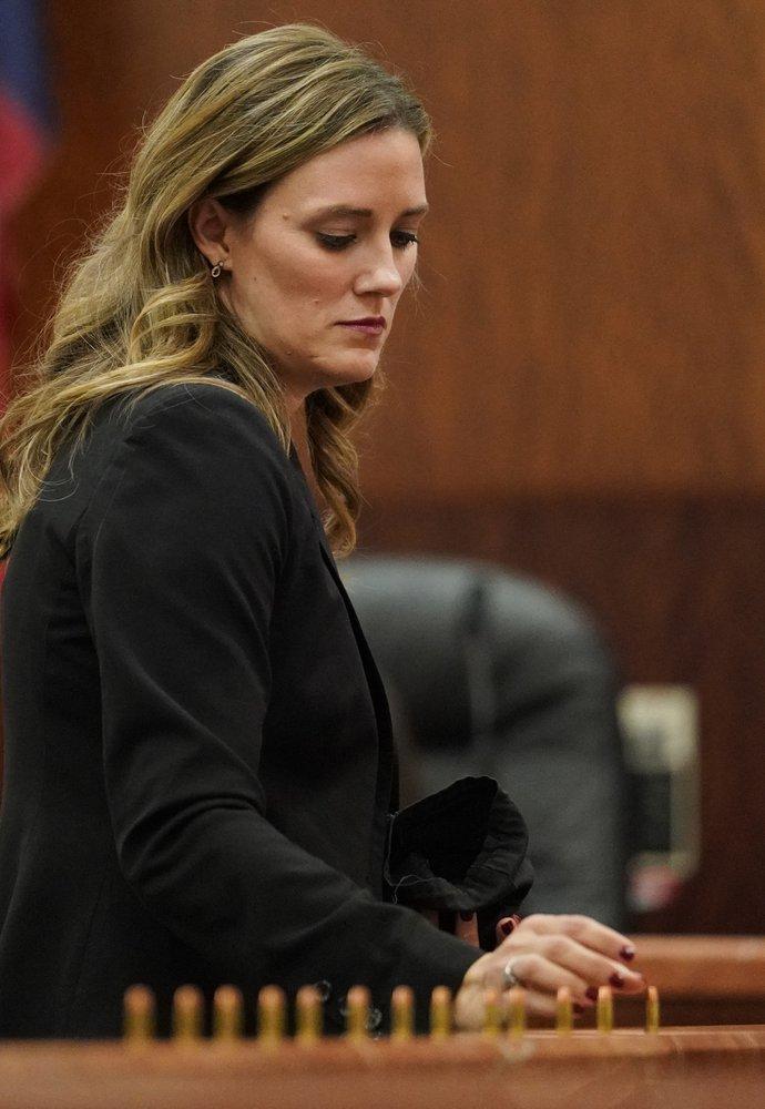 Samantha Knecht, prosecutor, places bullets in front of the jury as she speaks during the sentencing phase for Ronald Lee Haskell in Houston, Texas, on Oct. 11, 2019. (Melissa Phillip/Houston Chronicle via AP)