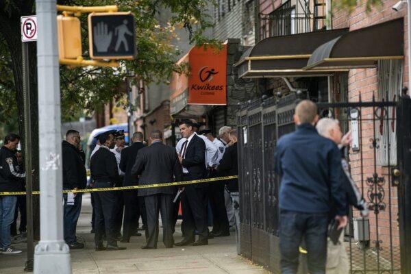 NYPD investigates the scene of a shooting in the Brooklyn borough of New York on Oct. 12, 2019. (AP Photo/Jeenah Moon)