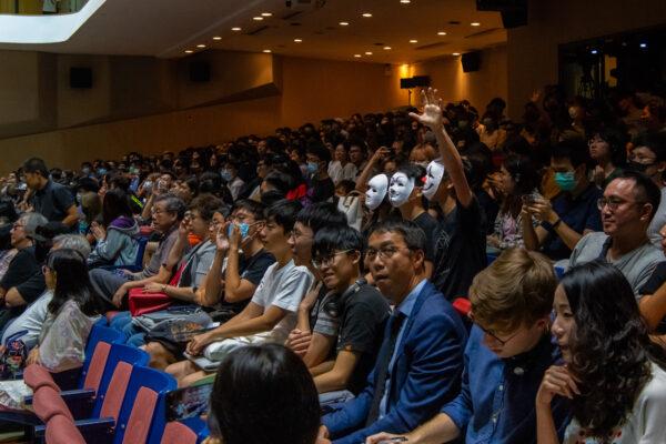 Students wear mask and react as Professor Rocky Tuan Sung-Chi, Vice-Chancellor and President of the Chinese University of Hong Kong, hold an open meeting with Hong Kong Chinese University's student in Hong Kong, on Oct. 10, 2019. (Billy H.C. Kwok/Getty Images)
