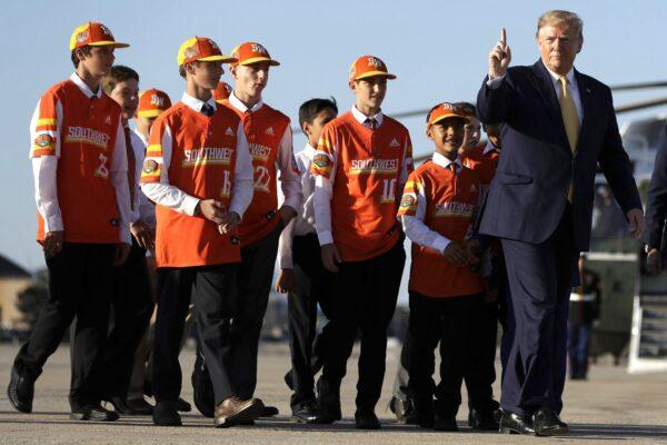 President Donald Trump boards Air Force One with Louisiana's Eastbank Little League team who won the 2019 Little League Baseball World Series, in Andrews Air Force Base, Md., on Oct. 11, 2019. (Evan Vucci/AP Photo)