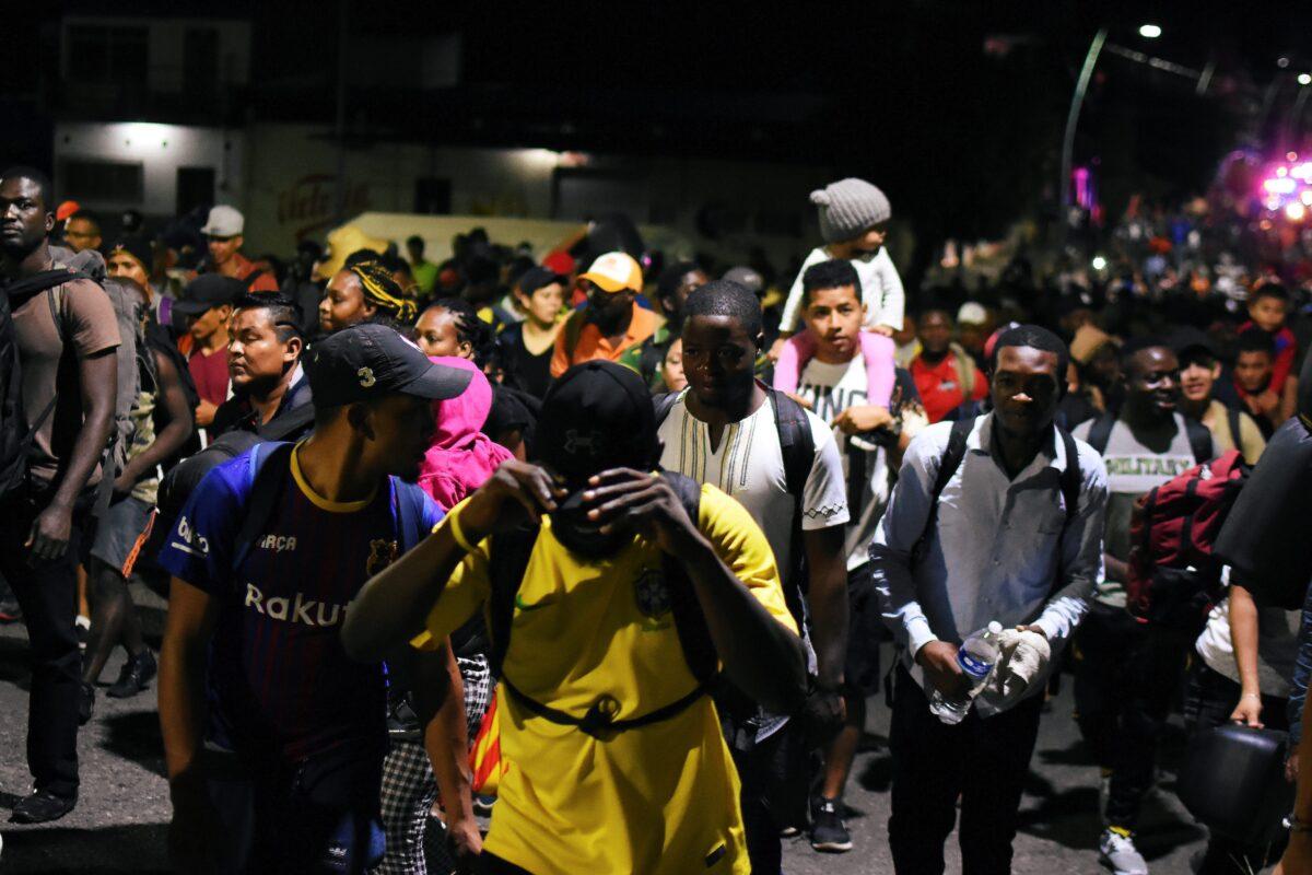 Migrants walk along a street in a caravan towards the United States, in Tapachula, Mexico, on Oct. 12, 2019. (Jacob Garcia/Reuters)