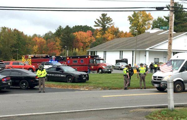 Police stand outside the New England Pentecostal Church after reports of a shooting in Pelham, N.H., on Oct. 12, 2019. (Siobhan Lopez/WMUR-TV via AP)