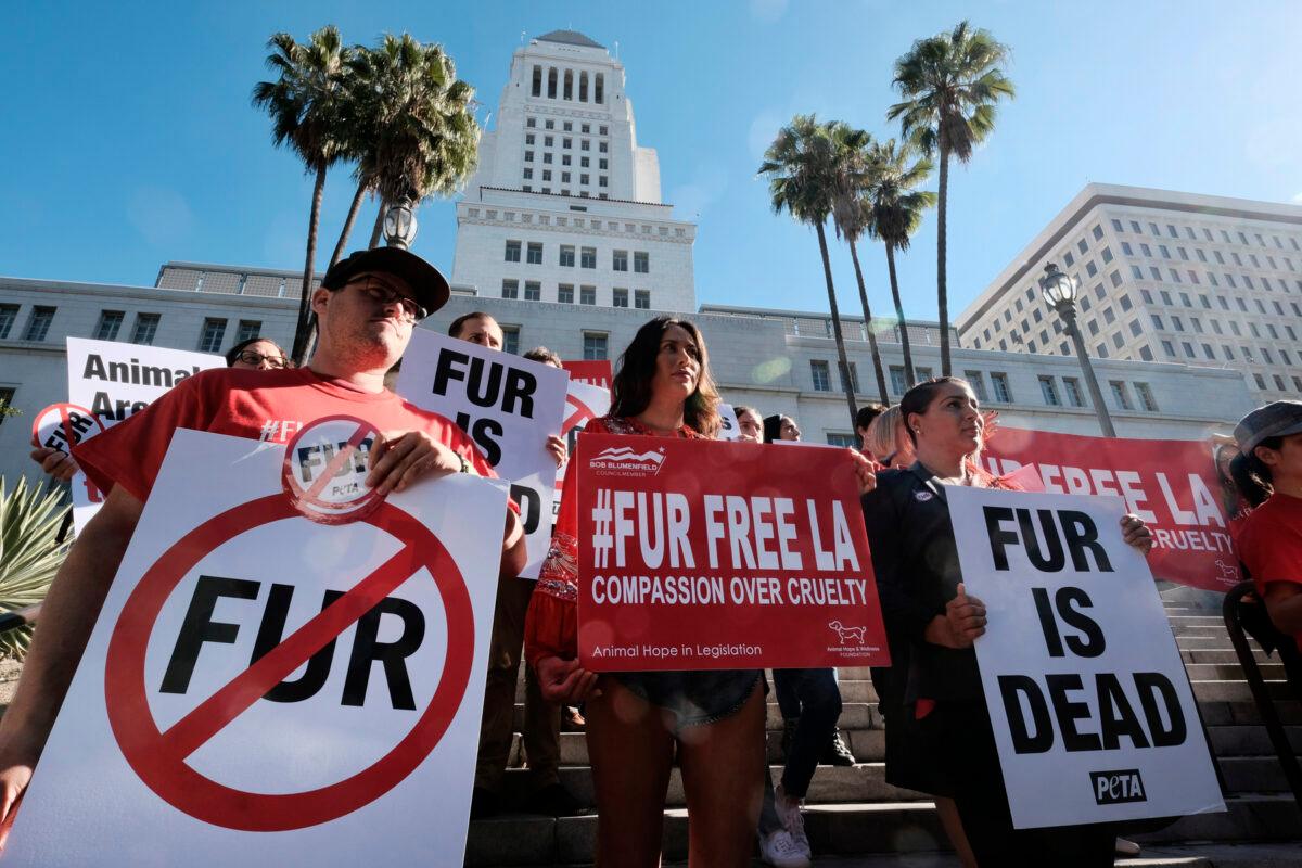 Protesters with the People for the Ethical Treatment of Animals (PETA) hold signs to ban fur in Los Angeles, on Sept. 18, 2018. (Richard Vogel/AP Photo)