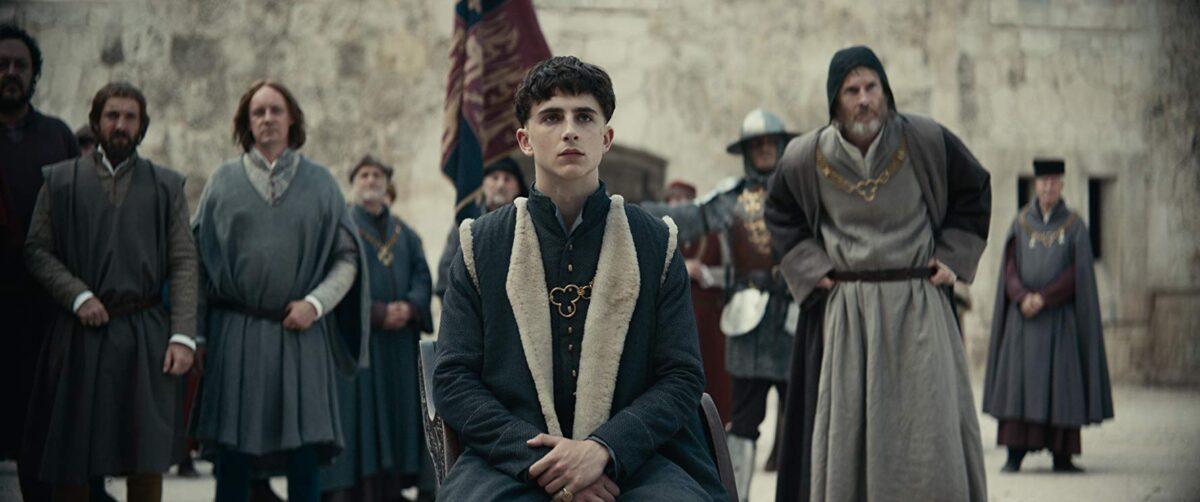 Timothée Chalamet (C) as King Henry V and Sean Harris (R) as William Gascoigne, in "The King." (Netflix)