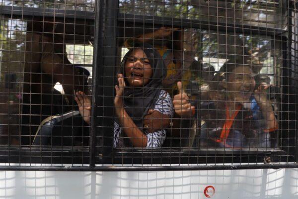 Tibetan students react inside a police vehicle after being detained during a protest against the visit of Chinese leader Xi Jinping near the ITC Grand Chola hotel in Chennai on Oct. 11, 2019. (STR/AFP via Getty Images)