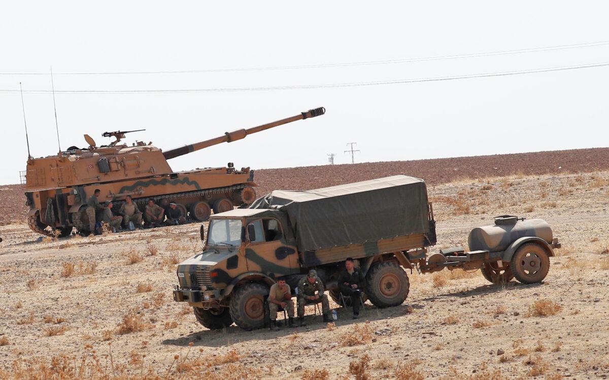 Turkish army vehicles and military personnel are stationed near the Turkish-Syrian border in Sanliurfa province, Turkey, on Oct. 12, 2019.(Murad Sezer/Reuters)