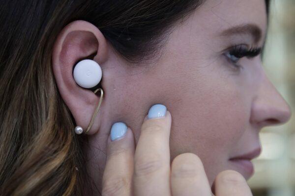 Isabelle Olsson, head of color & design for Nest, shows Pixel buds in her ear at Google in Mountain View, Calif., on Sept. 24, 2019. (Jeff Chiu/AP Photo)