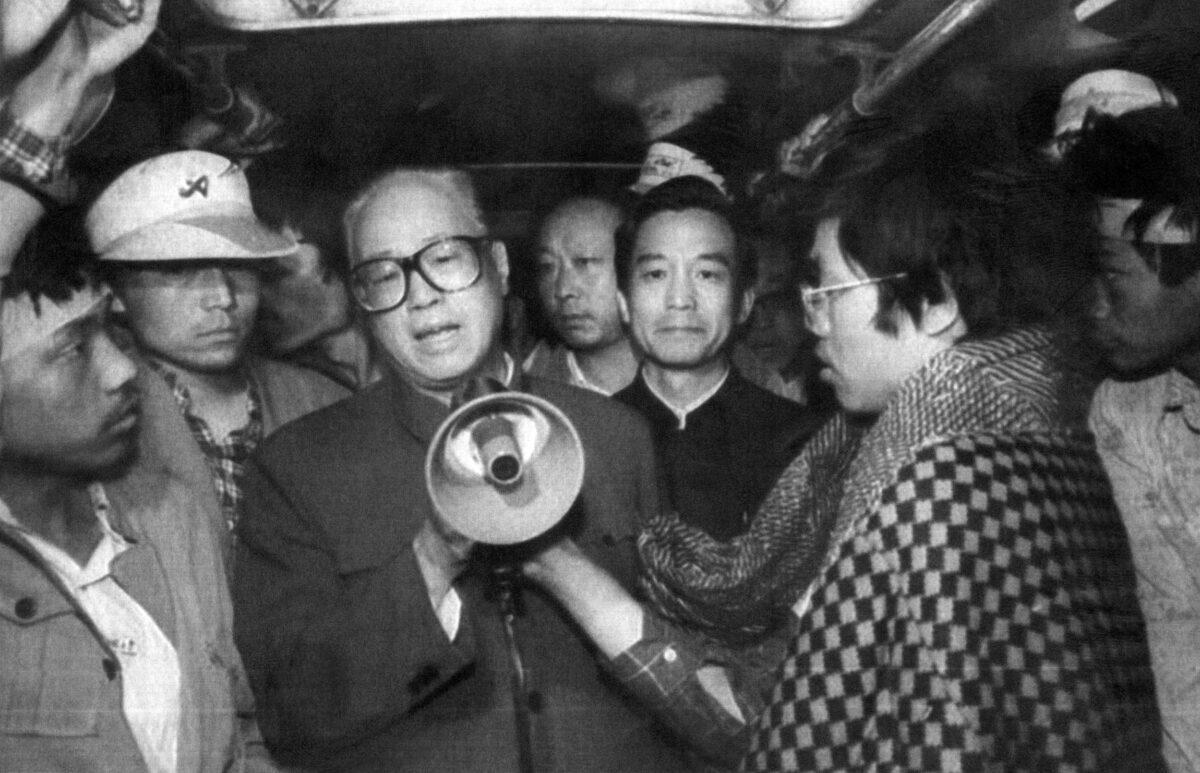 Chinese Communist Party chief Zhao Ziyang (C) addresses the student hunger strikers through a megaphone in one of the buses at Tiananmen Square in Beijing on May 19, 1989. (Xinhua/AFP/Getty Images)
