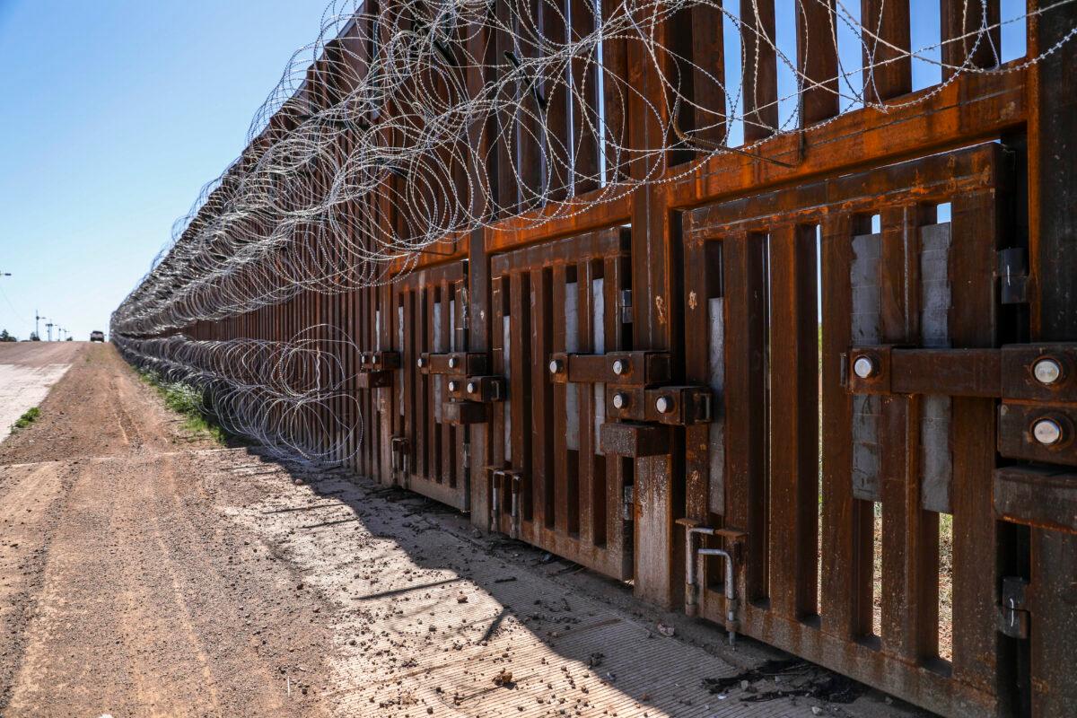 The flood gates sit within the U.S.-Mexico border fence west of Naco, Arizona, on May 8, 2019. The gates are left open during the rainy season of July 1 through Oct. 1 each year. (Charlotte Cuthbertson/The Epoch Times)