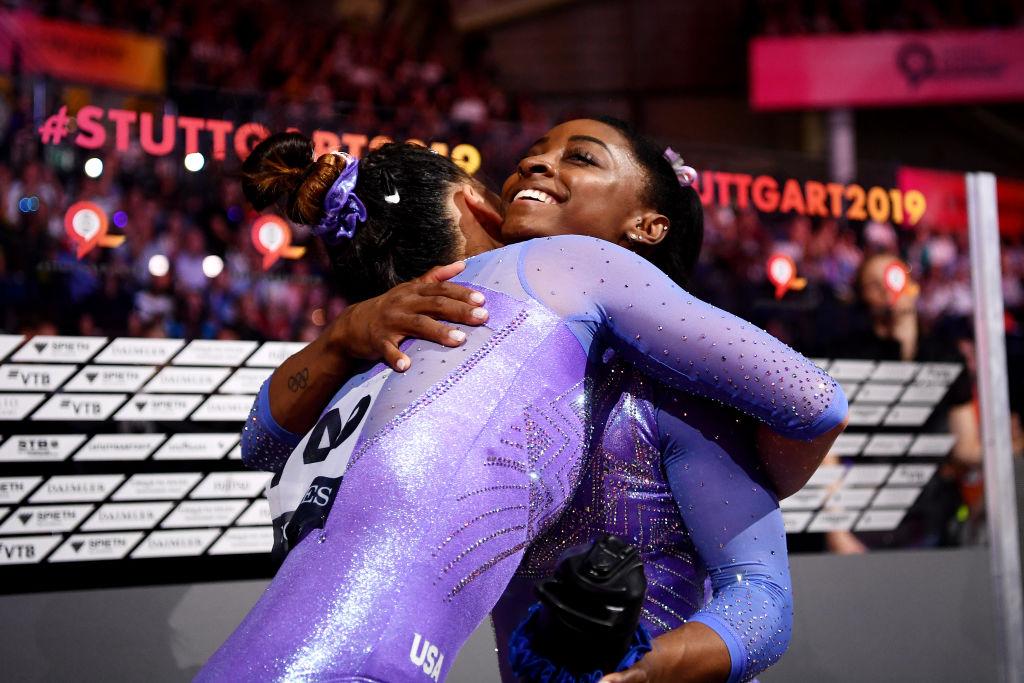 Biles celebrates winning gold in the Women's Floor Final by hugging the USA's Sunisa Lee (©Getty Images | <a href="https://www.gettyimages.com.au/detail/news-photo/simone-biles-of-the-united-states-celebrates-winning-gold-news-photo/1180785578">Laurence Griffiths</a>)