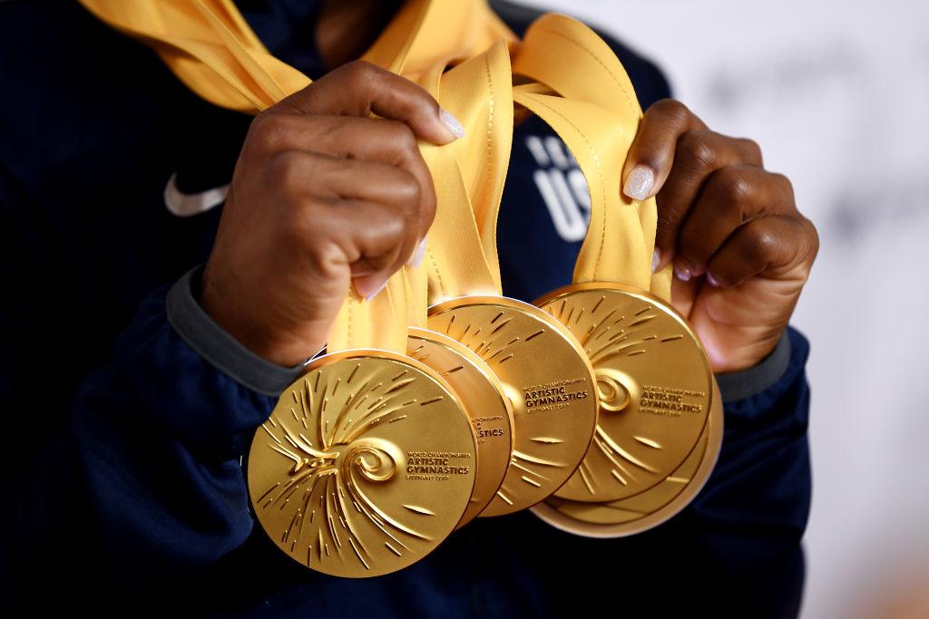 Biles of the USA poses for photos with her multiple gold medals during day 10 of the Championships in Stuttgart, Germany. (©Getty Images | <a href="https://www.gettyimages.com.au/detail/news-photo/detailed-view-as-simone-biles-of-the-united-states-poses-news-photo/1180798385">Laurence Griffiths</a>)