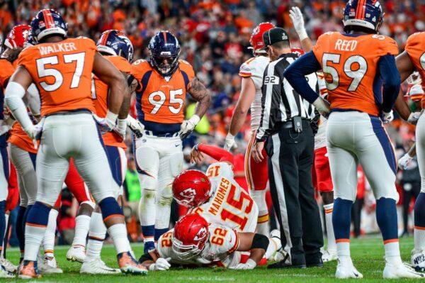 Patrick Mahomes #15 of the Kansas City Chiefs signals for help after sustaining an injury in the second quarter of a game against the Denver Broncos at Empower Field at Mile High in Denver, Colo. on Oct. 17, 2019. (Dustin Bradford/Getty Images)