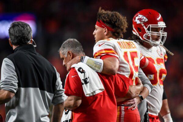 Patrick Mahomes #15 of the Kansas City Chiefs is helped off the field by trainers after sustaining an injury in the second quarter of a game against the Denver Broncos at Empower Field at Mile High in Denver, Colo. on Oct. 17, 2019. (Dustin Bradford/Getty Images)